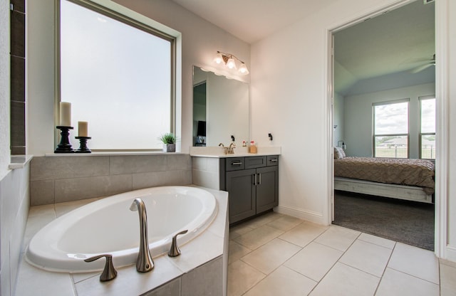 ensuite bathroom with tile patterned flooring, vanity, ensuite bath, a ceiling fan, and a bath