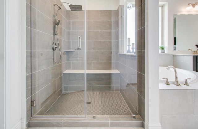 bathroom with a bath and a stall shower