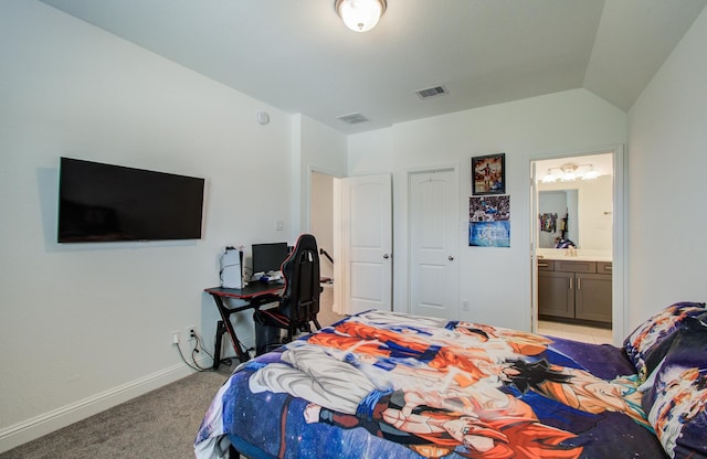 bedroom with baseboards, ensuite bathroom, light carpet, and visible vents