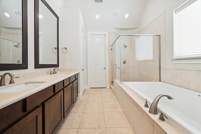 bathroom with visible vents, a shower stall, a sink, and a garden tub