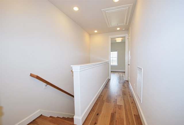 9443 Fannin St, Houston, TX 77045 - corridor with an upstairs landing, attic access, baseboards, light wood finished floors, and recessed lighting