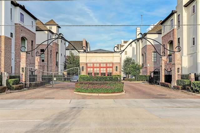 surrounding community featuring fence, a residential view, and a gate