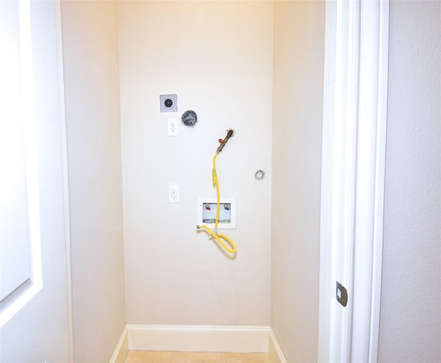9443 Fannin St, Houston, TX 77045 - clothes washing area featuring hookup for a washing machine, hookup for an electric dryer, baseboards, and light tile patterned floors