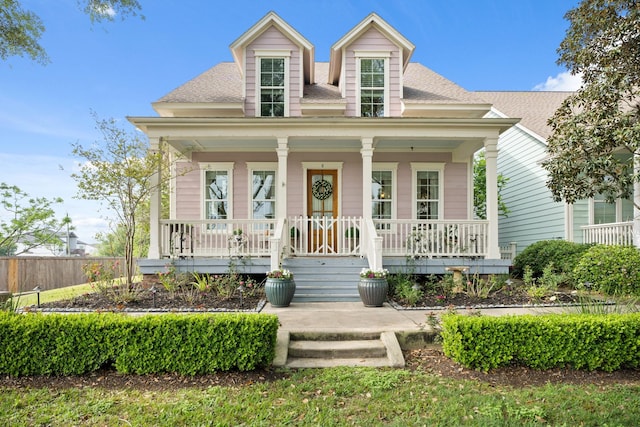 8 Latitude Ln, Galveston, TX 77554 - view of front of home with roof with shingles, fence, and covered porch