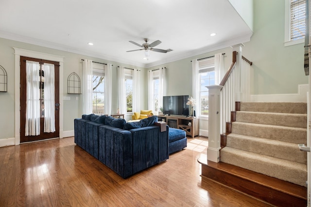 8 Latitude Ln, Galveston, TX 77554 - living room with a ceiling fan, stairway, baseboards, light wood finished floors, and ornamental molding