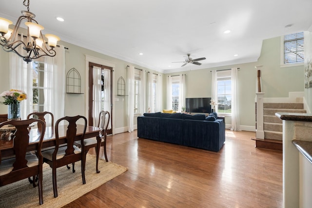 8 Latitude Ln, Galveston, TX 77554 - living area featuring baseboards, ceiling fan with notable chandelier, stairs, and wood finished floors