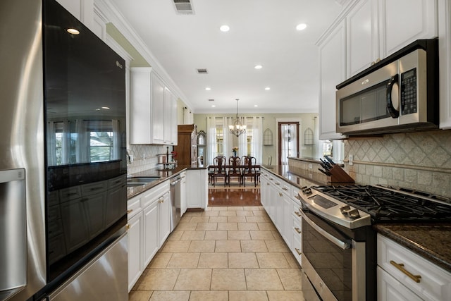 8 Latitude Ln, Galveston, TX 77554 - kitchen featuring visible vents, a notable chandelier, stainless steel appliances, recessed lighting, and white cabinetry