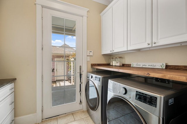 8 Latitude Ln, Galveston, TX 77554 - laundry area with cabinet space, light tile patterned flooring, and washing machine and clothes dryer