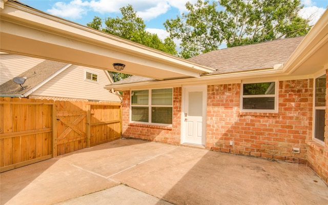 2706 Williams Grant St, Sugar Land, TX 77479 - doorway to property with roof with shingles, fence, brick siding, a gate, and a patio area
