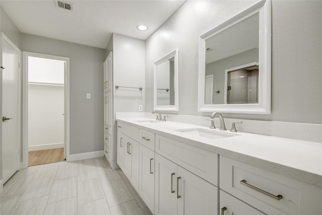 2706 Williams Grant St, Sugar Land, TX 77479 - bathroom featuring a sink, a walk in closet, double vanity, and visible vents