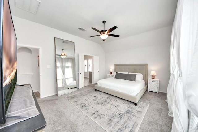 bedroom with carpet flooring, ceiling fan, visible vents, and attic access