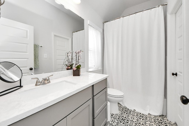 bathroom with tile patterned flooring, a shower with shower curtain, toilet, and vanity