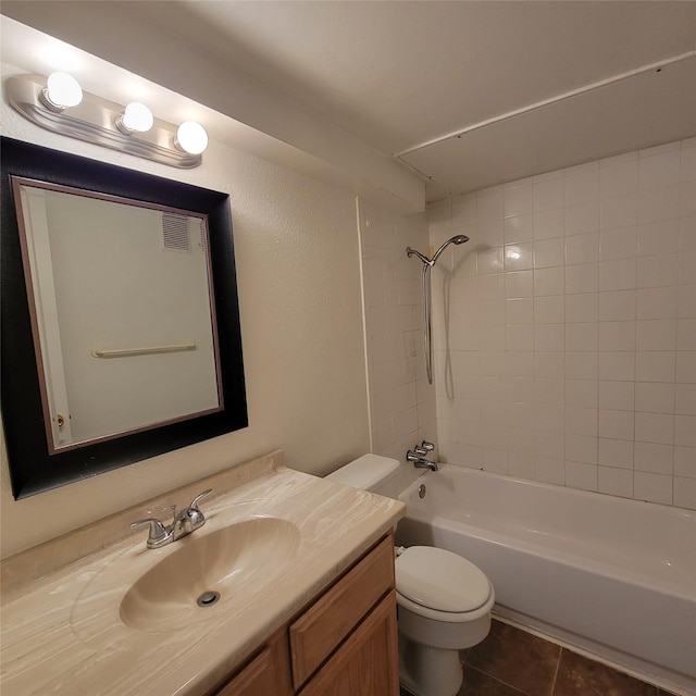 full bath featuring visible vents, tile patterned flooring, vanity, toilet, and washtub / shower combination