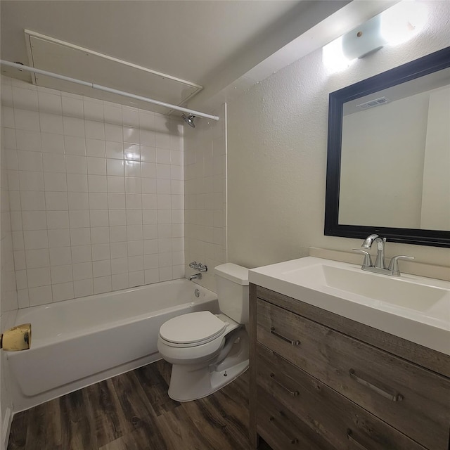 full bathroom with vanity, shower / bathtub combination, toilet, wood finished floors, and visible vents