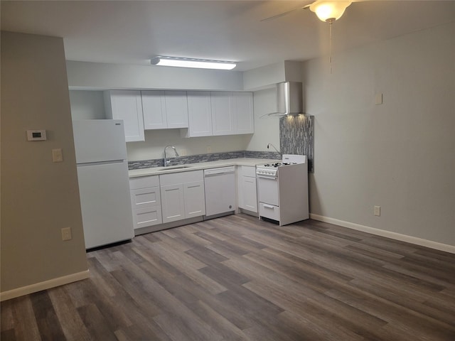 kitchen featuring wall chimney range hood, a sink, white appliances, baseboards, and dark wood-style floors