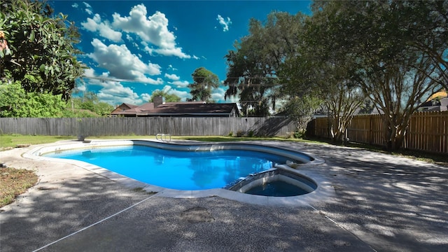 view of swimming pool with a patio, a fenced backyard, and a pool with connected hot tub