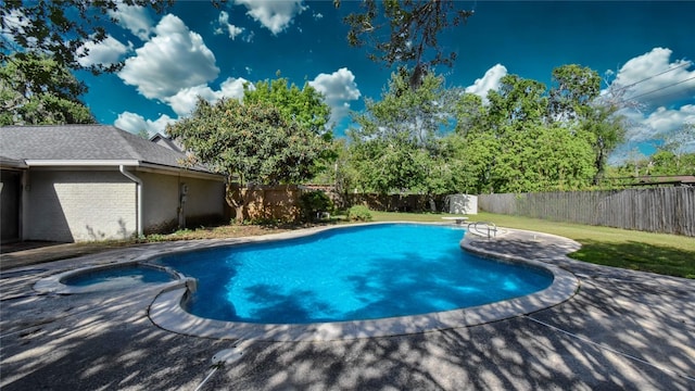 view of swimming pool featuring a fenced backyard, a diving board, a pool with connected hot tub, and a patio area