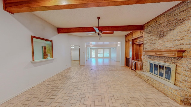 unfurnished living room featuring ceiling fan, a brick fireplace, baseboards, beamed ceiling, and brick floor