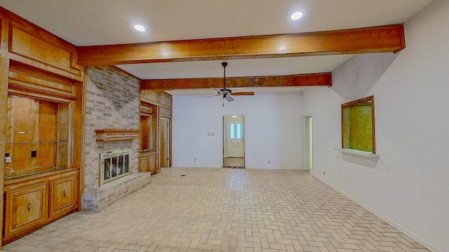 unfurnished living room featuring a brick fireplace, beamed ceiling, baseboards, ceiling fan, and brick floor
