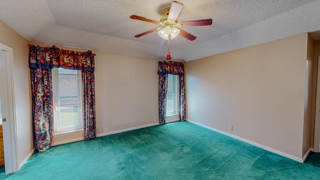 unfurnished room with a ceiling fan, baseboards, carpet, and a textured ceiling