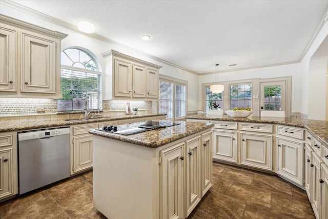 kitchen featuring a sink, dishwasher, cream cabinets, and a wealth of natural light
