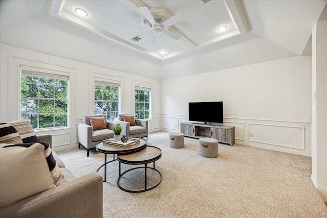 carpeted living room featuring visible vents, ornamental molding, a decorative wall, ceiling fan, and coffered ceiling