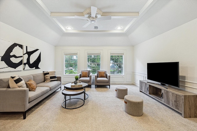 carpeted living room featuring crown molding, ceiling fan, coffered ceiling, and a wainscoted wall