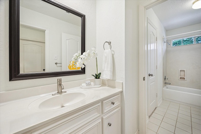bathroom featuring tile patterned flooring, bathing tub / shower combination, and vanity
