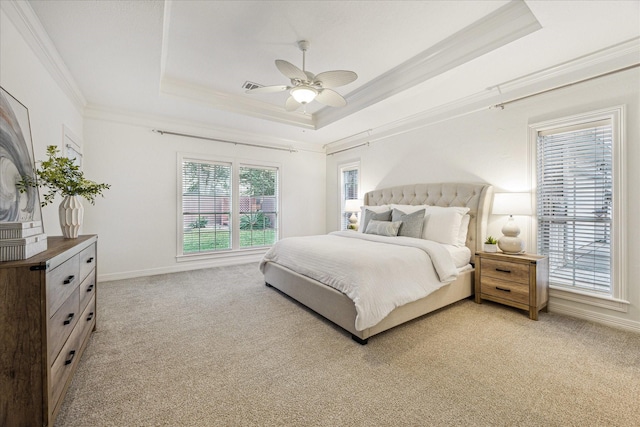 bedroom with a raised ceiling, ornamental molding, and light colored carpet