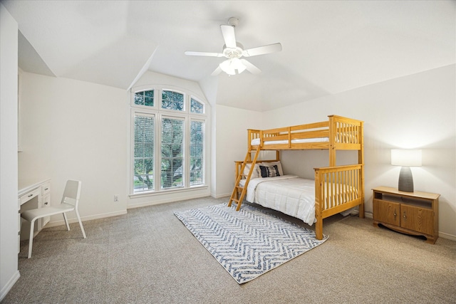 bedroom with carpet flooring, baseboards, vaulted ceiling, and ceiling fan