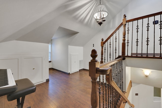 interior space with an inviting chandelier, wood finished floors, and lofted ceiling
