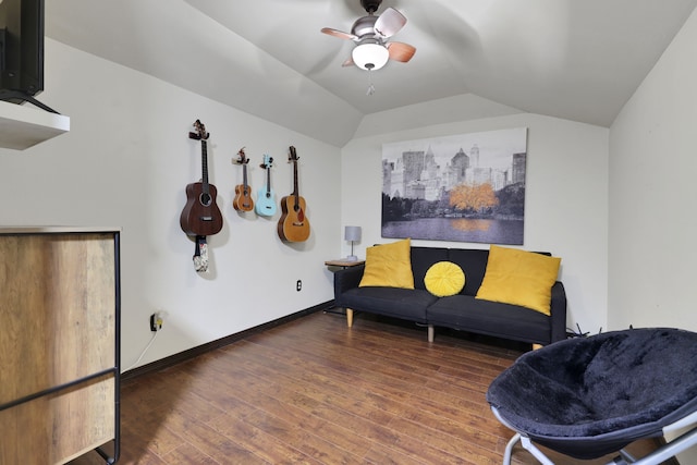 living area featuring a ceiling fan, baseboards, wood finished floors, and lofted ceiling