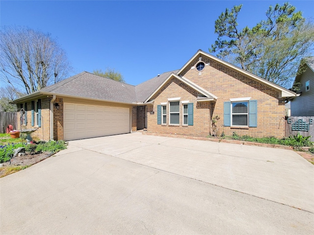 ranch-style home featuring driveway, roof with shingles, brick siding, fence, and an attached garage