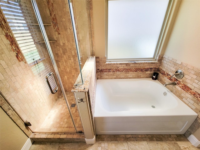 full bathroom featuring a garden tub and a stall shower