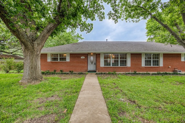 ranch-style home with brick siding and a front lawn