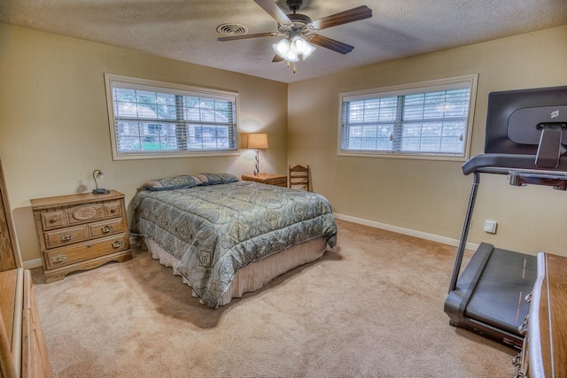 bedroom with ceiling fan, carpet, a textured ceiling, and visible vents