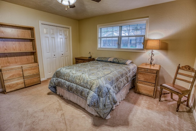 bedroom featuring a closet, a ceiling fan, carpet, and baseboards