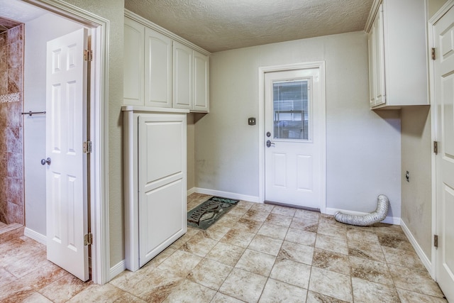 laundry area featuring a textured ceiling