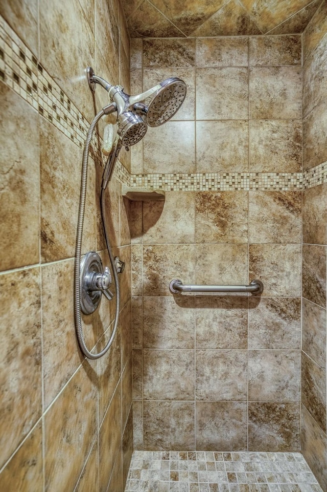 interior details featuring tiled shower