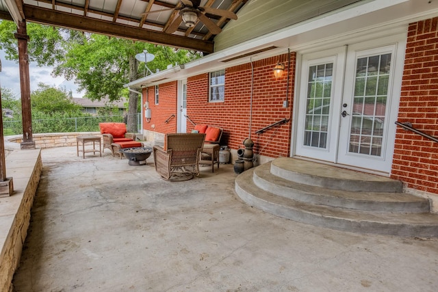 view of patio / terrace featuring ceiling fan, fence, french doors, and entry steps