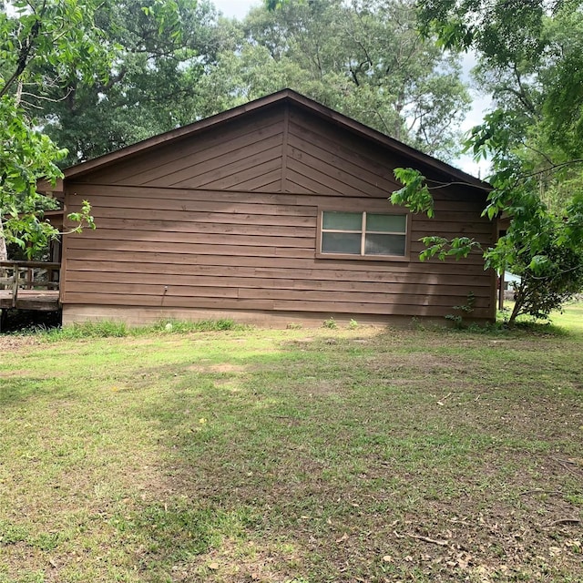 view of property exterior with a lawn