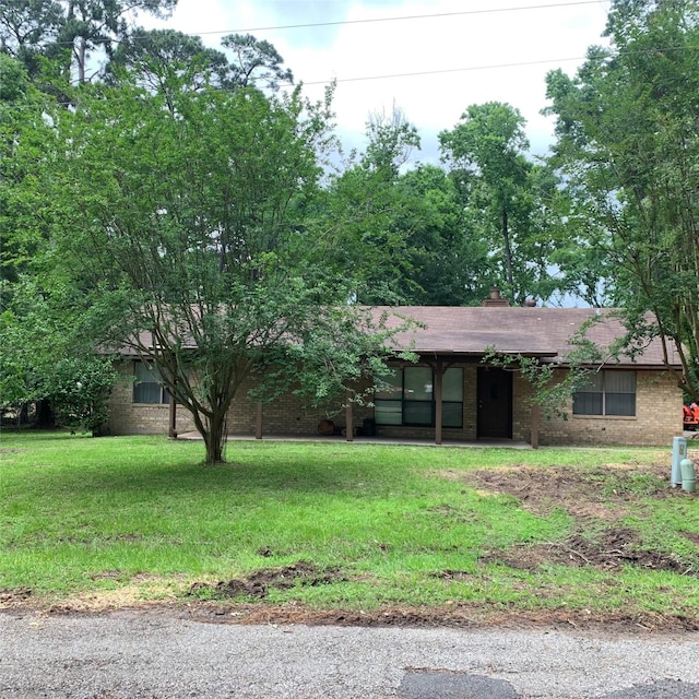 169 Lakeview Pnes, Livingston, TX 77351 - view of front of house with brick siding and a front yard