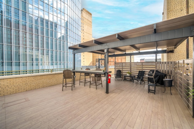 wooden terrace featuring a grill