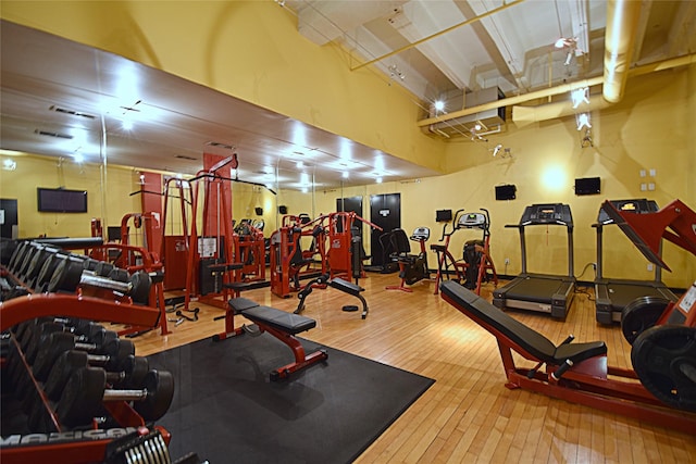 exercise room with wood-type flooring