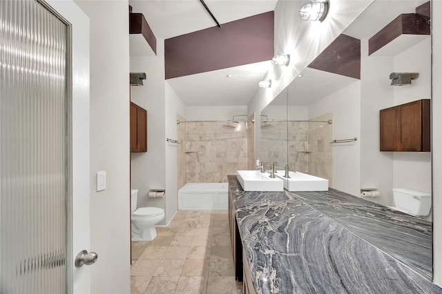 bathroom with vanity, baseboards, and toilet