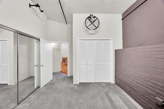 unfurnished bedroom with carpet floors and multiple closets