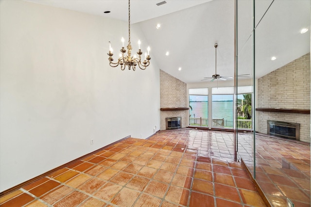 unfurnished living room featuring high vaulted ceiling, a fireplace, and ceiling fan with notable chandelier