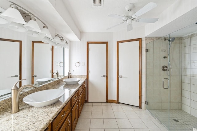 full bathroom with visible vents, a sink, tile patterned floors, and a shower stall