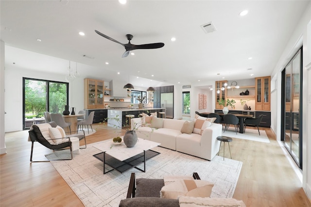 living room featuring plenty of natural light, recessed lighting, light wood-style flooring, and visible vents