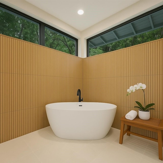 bathroom with tile patterned flooring, a soaking tub, and recessed lighting